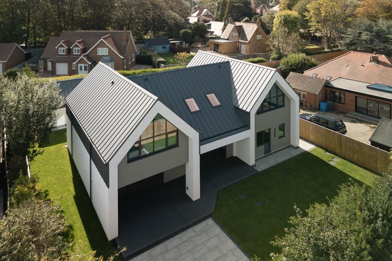 Aerial view of modern home with metal and green roof